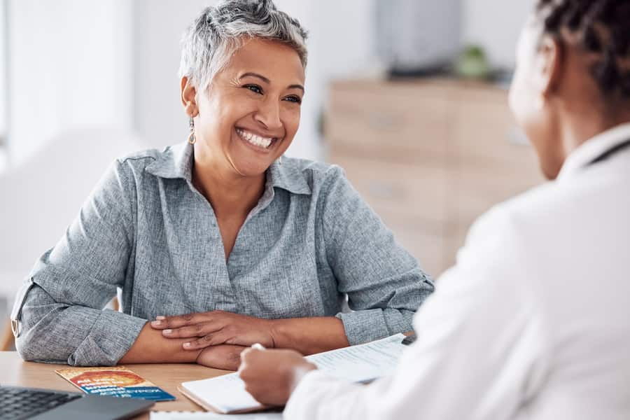 A woman speaking privately with a healthcare professional
